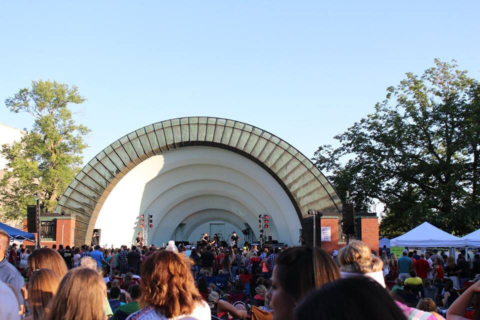 A group of people watching a concert at the Bandshell