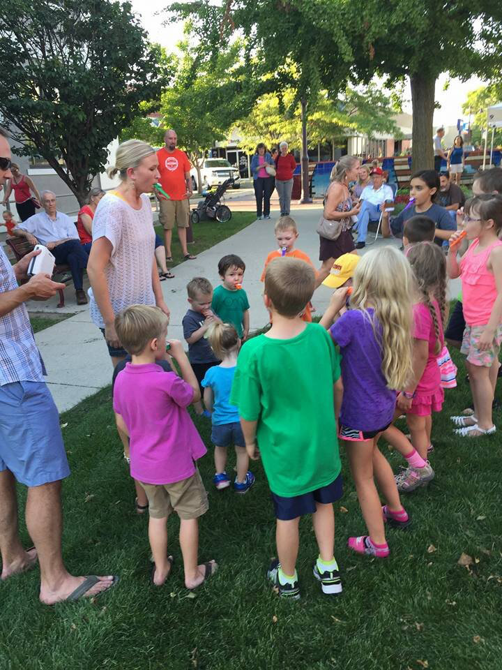 A group of kids with kazoos at Music Walk in Downtown Ames